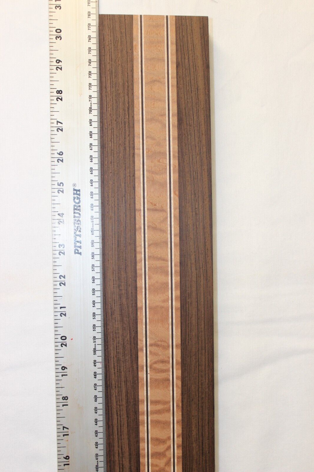 Quilted sapele, wenge and flame maple laminated guitar neck blank.