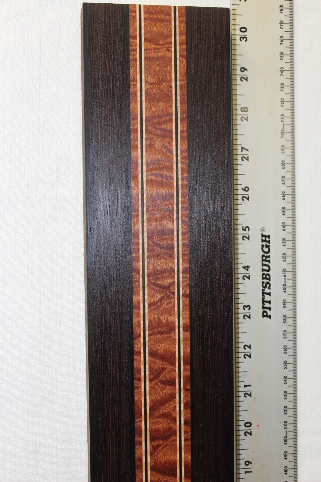 Quilted sapele, wenge and flame maple laminated guitar neck blank.