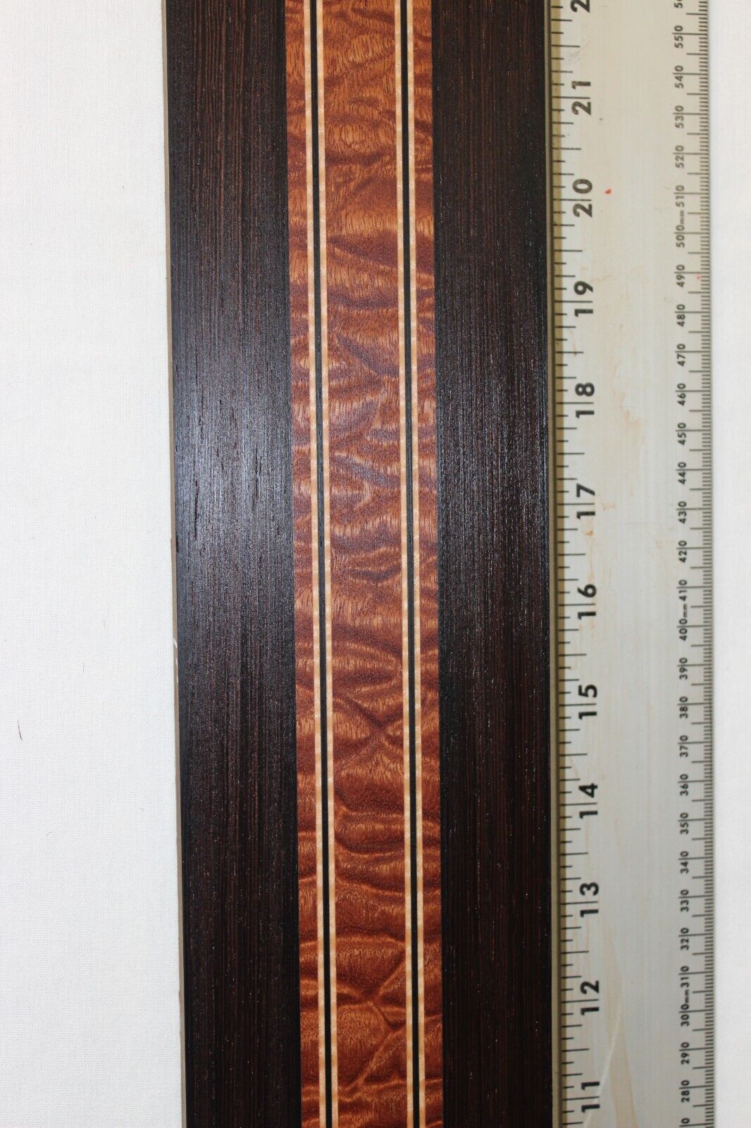 Quilted sapele, wenge and flame maple laminated guitar neck blank.