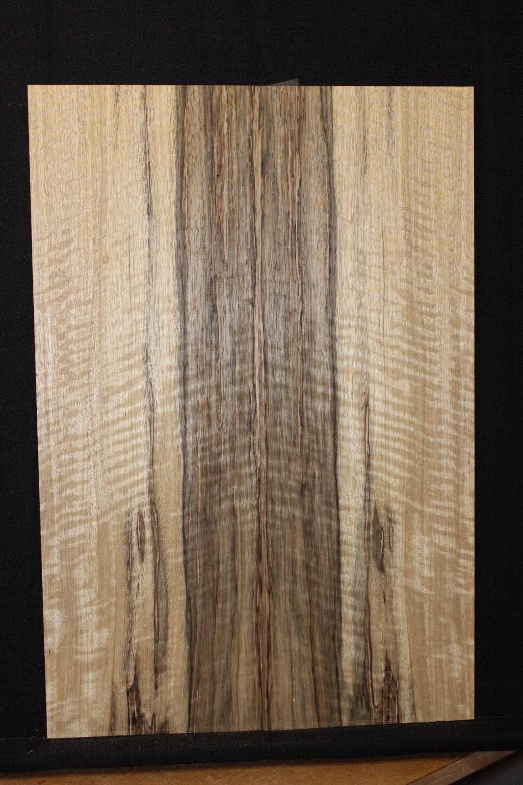 Curly black limba / korina figured book matched guitar top.