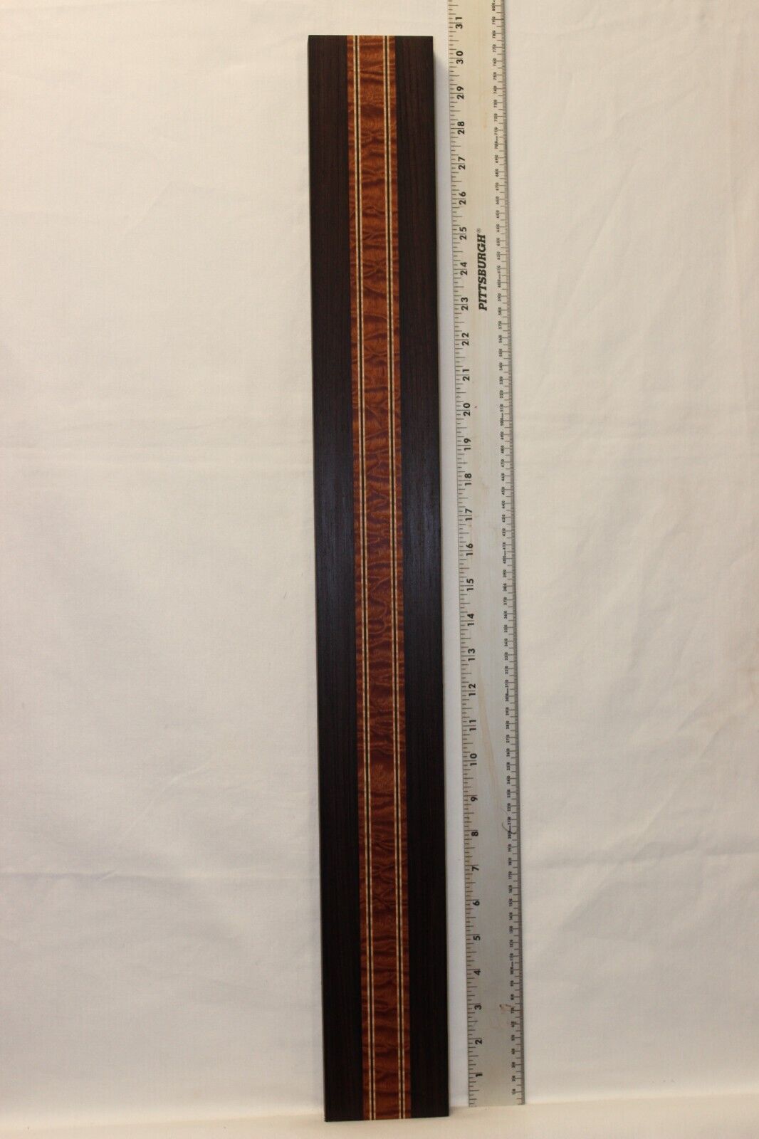 Quilted sapele, wenge and flame maple laminated guitar neck blank.