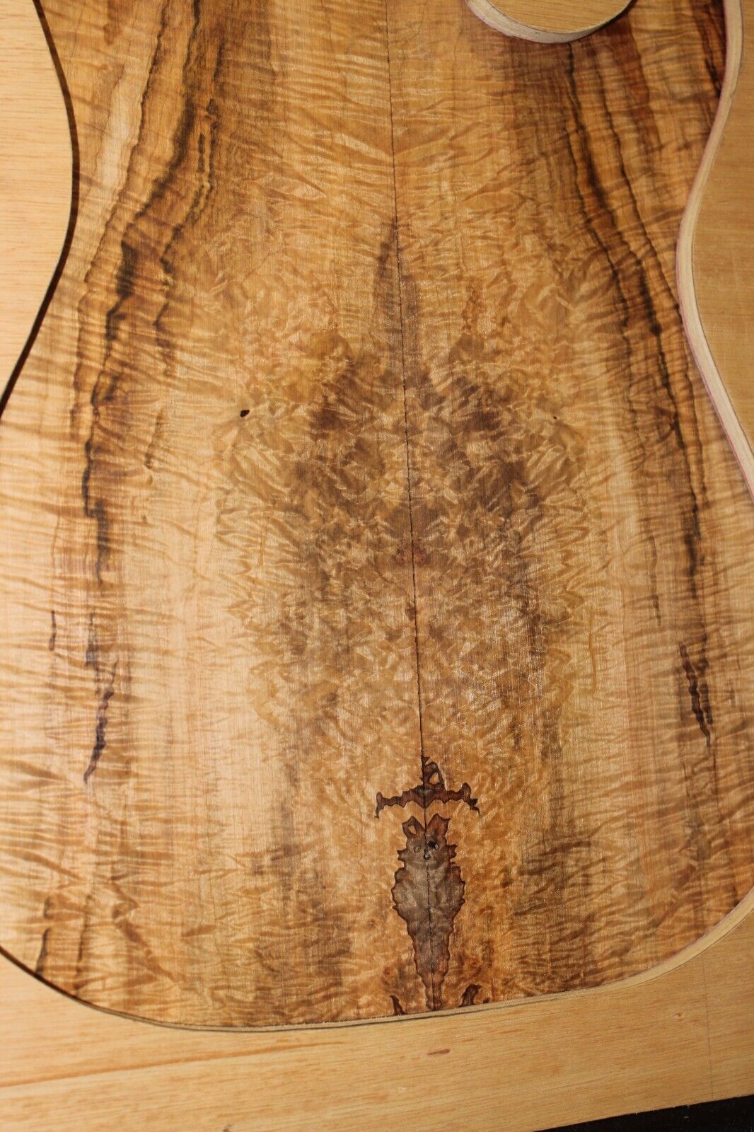 Figured ambrosia maple book matched guitar top, insane figure and color.