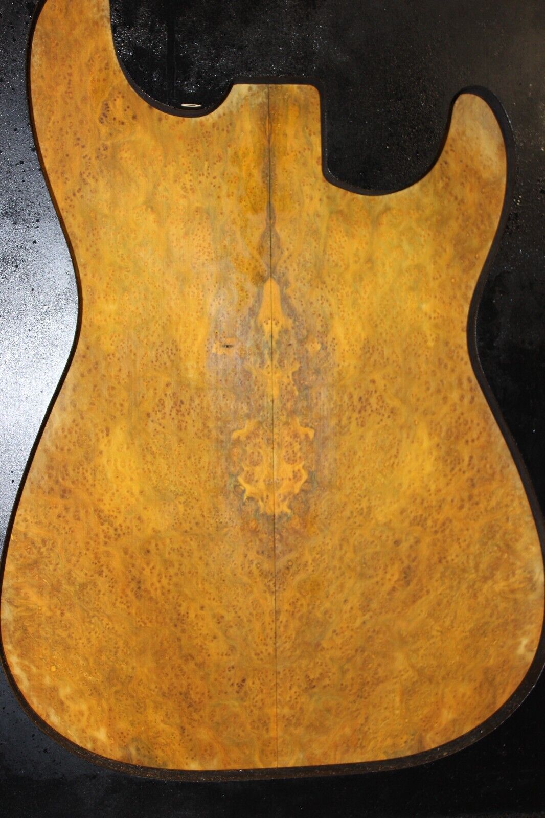Golden Amboyna burl book matched guitar top.