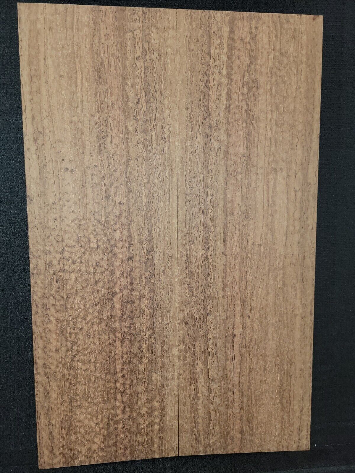 Pomelle figured bubinga electric guitar drop top.