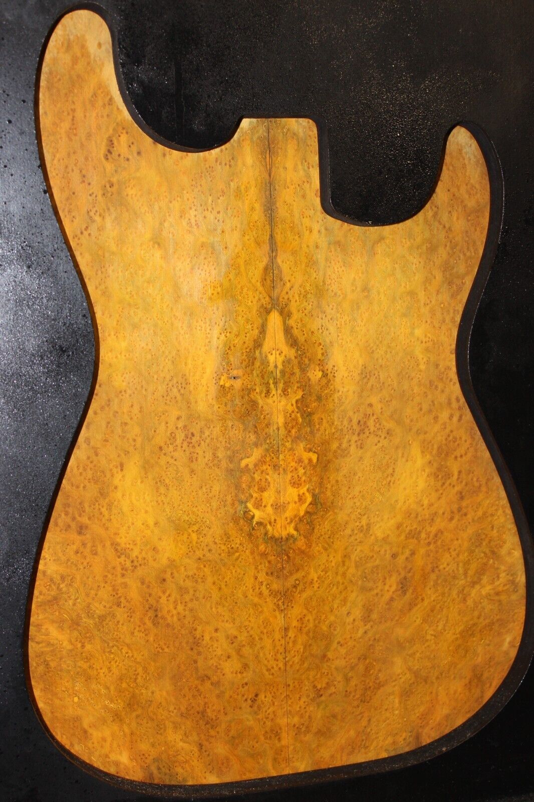 Golden Amboyna burl book matched guitar top.