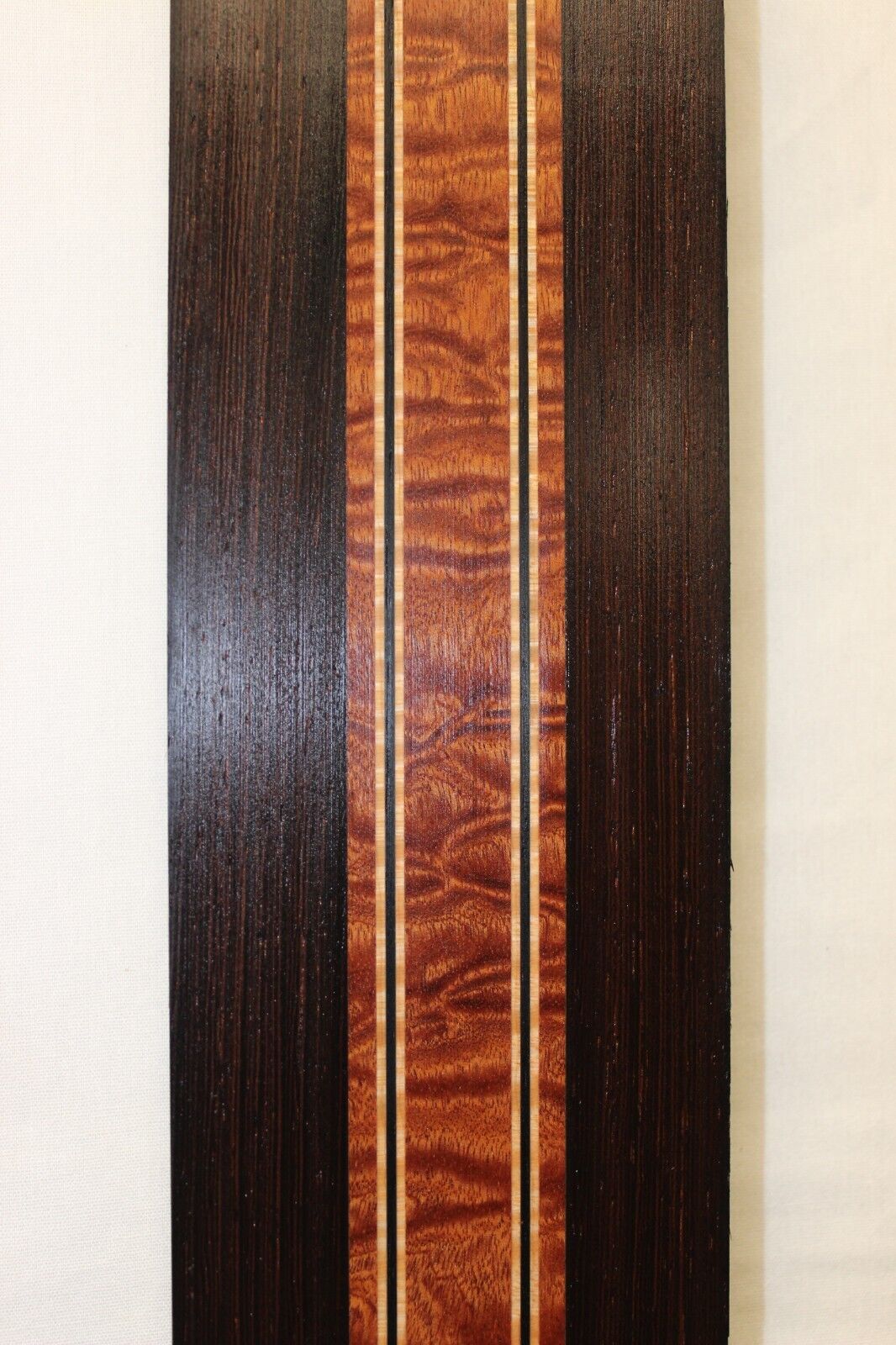 Quilted sapele, wenge and flame maple laminated guitar neck blank.
