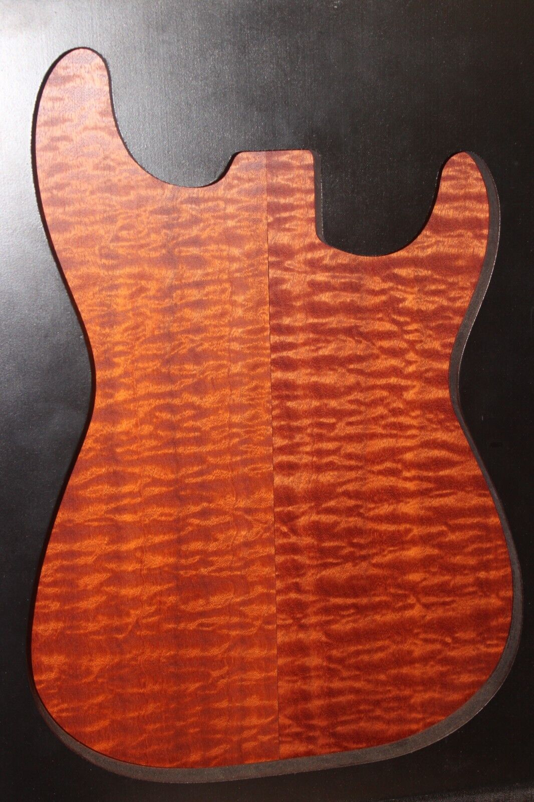 Quilted figured sapele guitar bookmatched drop top.