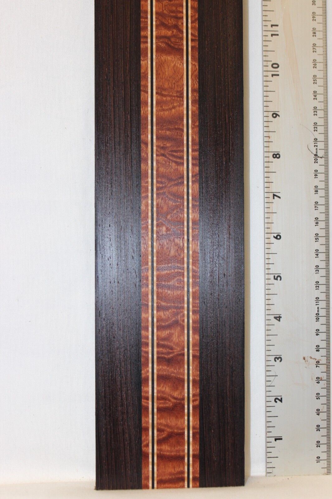 Quilted sapele, wenge and flame maple laminated guitar neck blank.