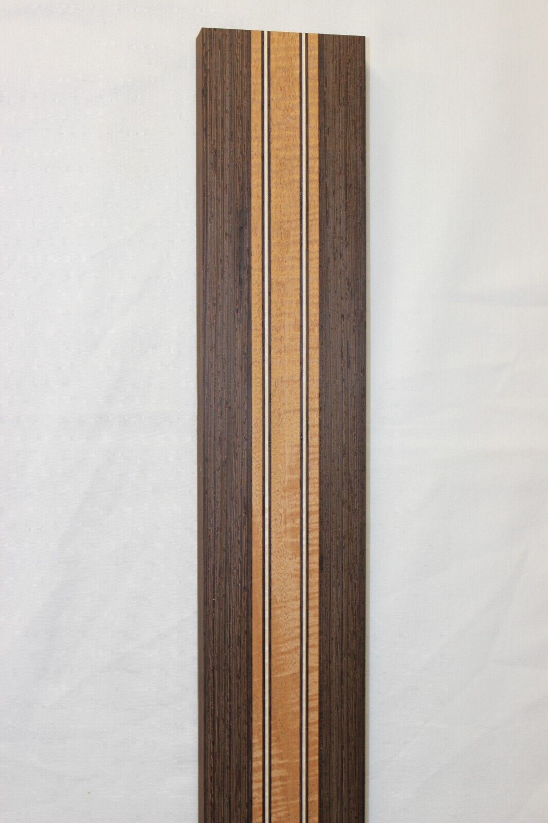 Figured mahogany, wenge and hard maple laminated guitar neck blank.