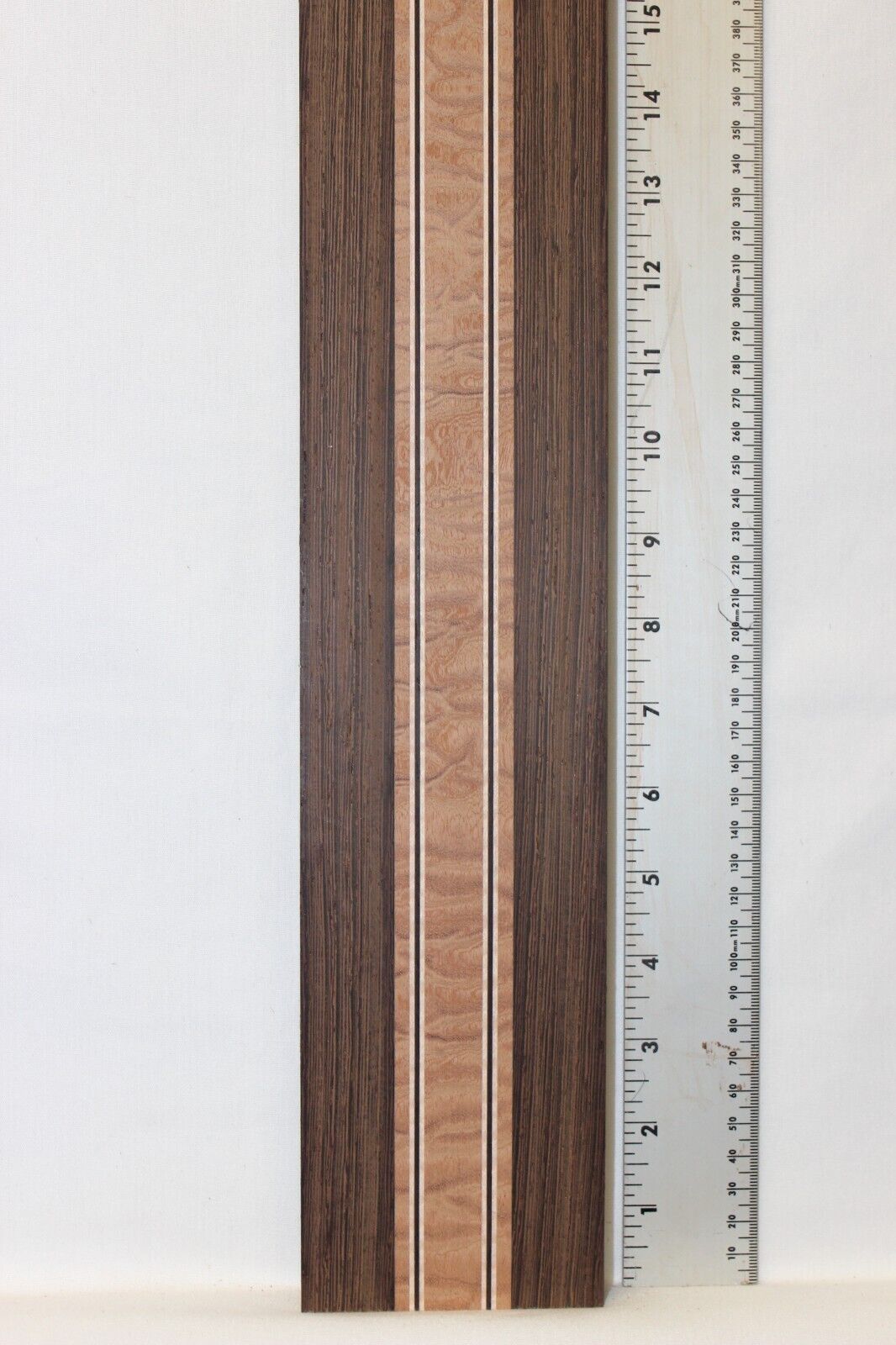 Quilted sapele, wenge and flame maple laminated guitar neck blank.
