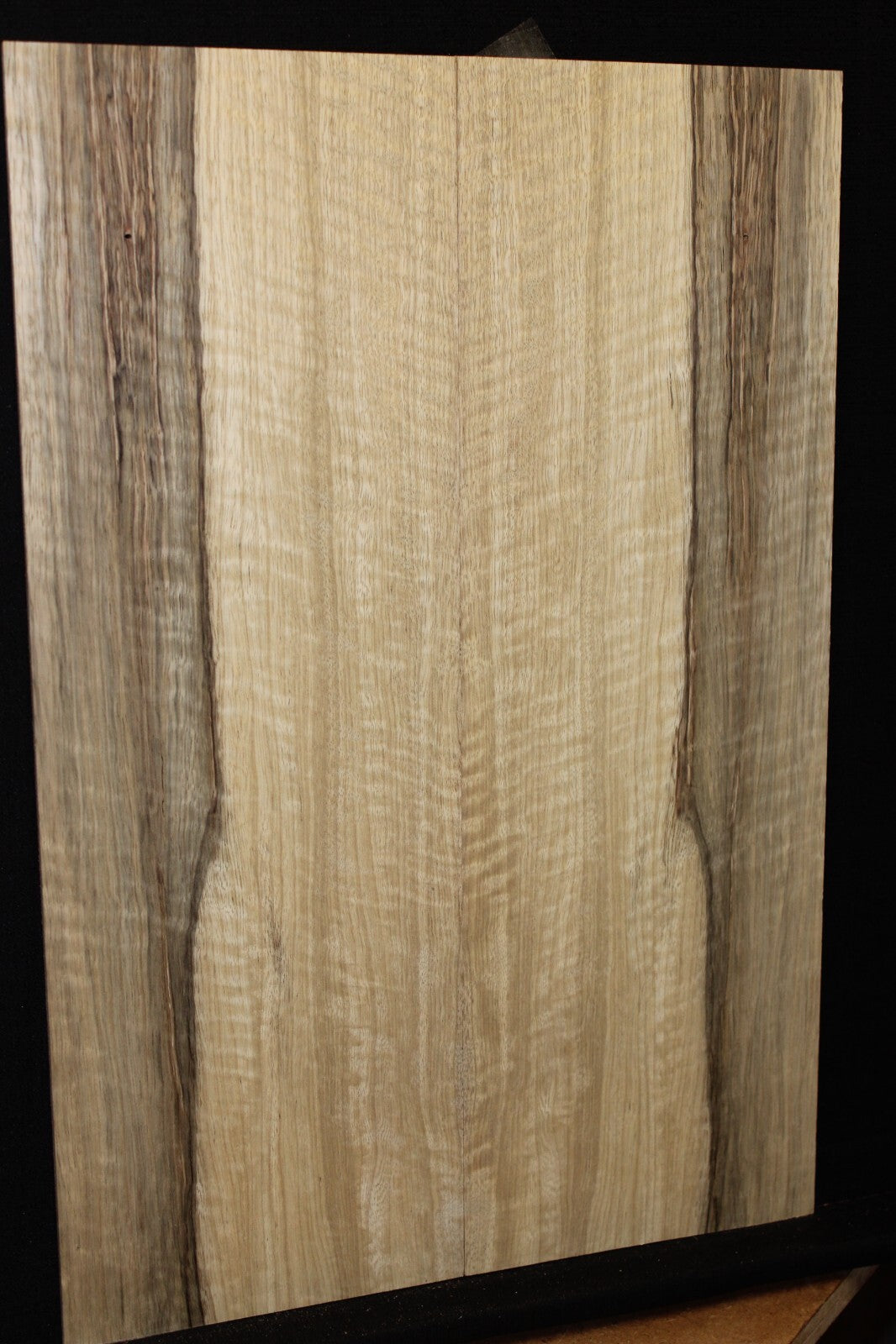 Curly black limba / korina figured book matched guitar top.