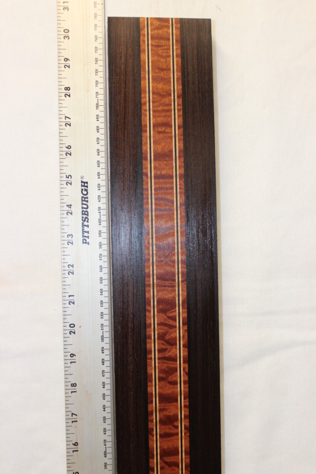 Quilted sapele, wenge and flame maple laminated guitar neck blank.