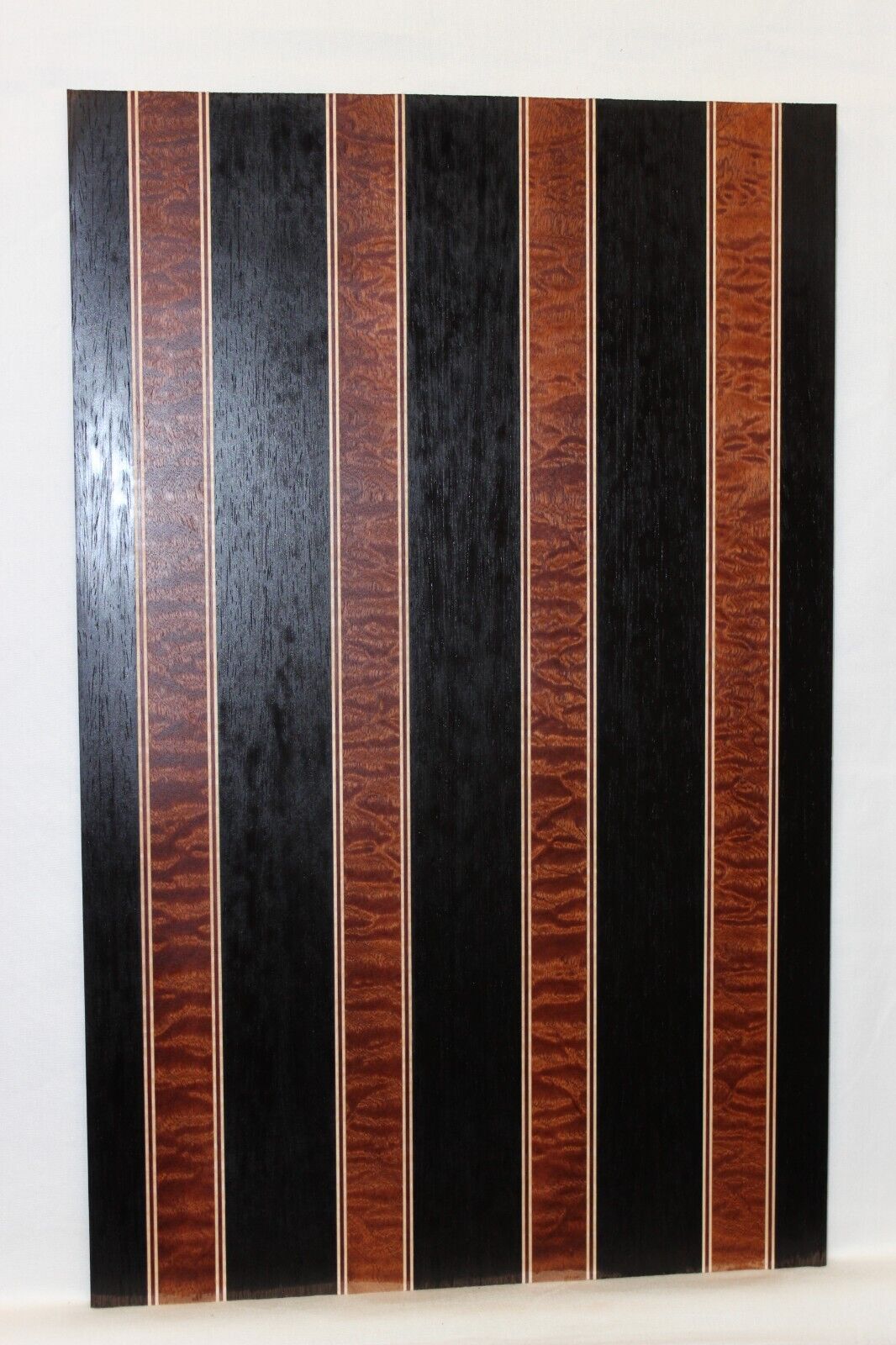 Quilted sapele, wenge, maple and purple-heart laminated electric guitar top.