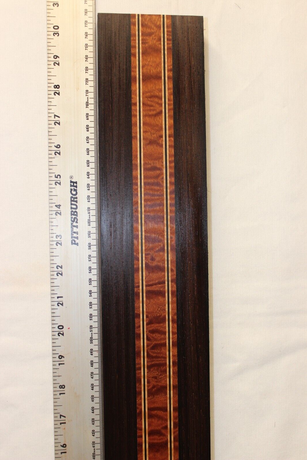 Quilted sapele, wenge and flame maple laminated guitar neck blank.
