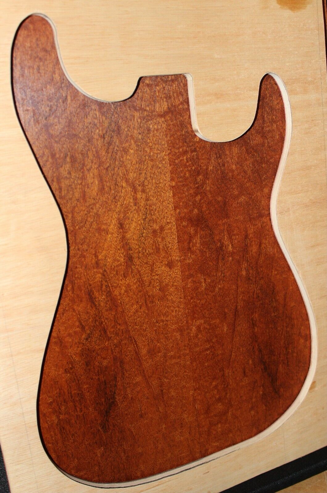 Figured genuine mahogany bookmatched electric guitar drop top.