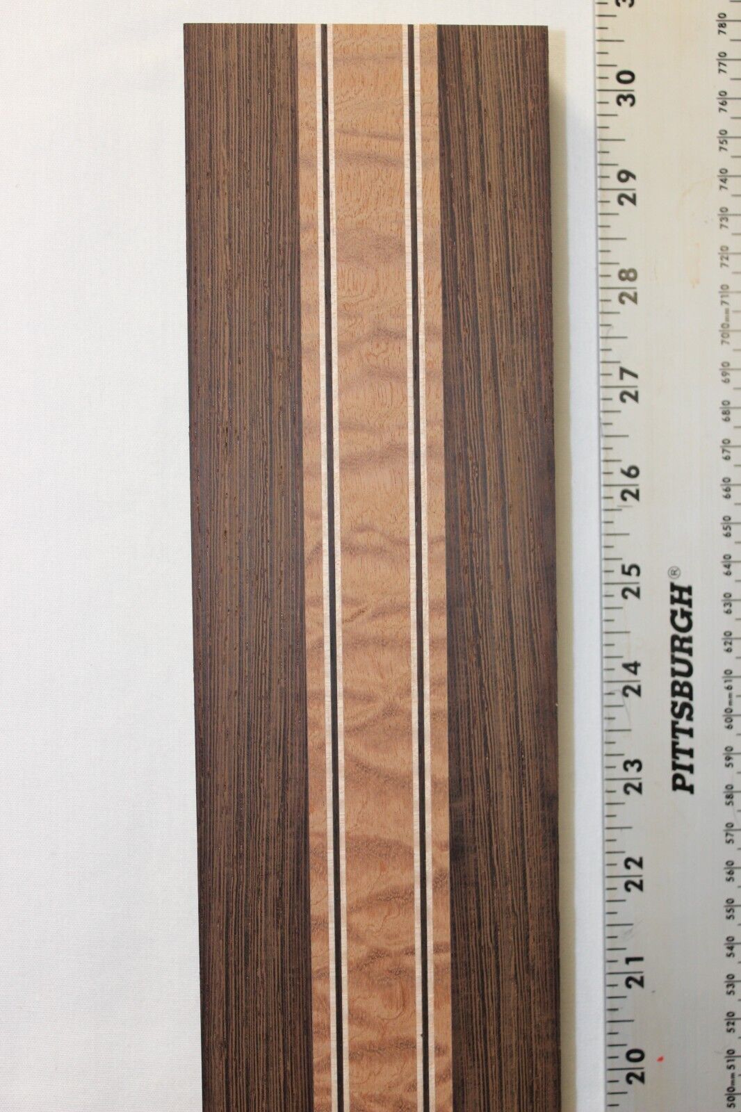 Quilted sapele, wenge and flame maple laminated guitar neck blank.