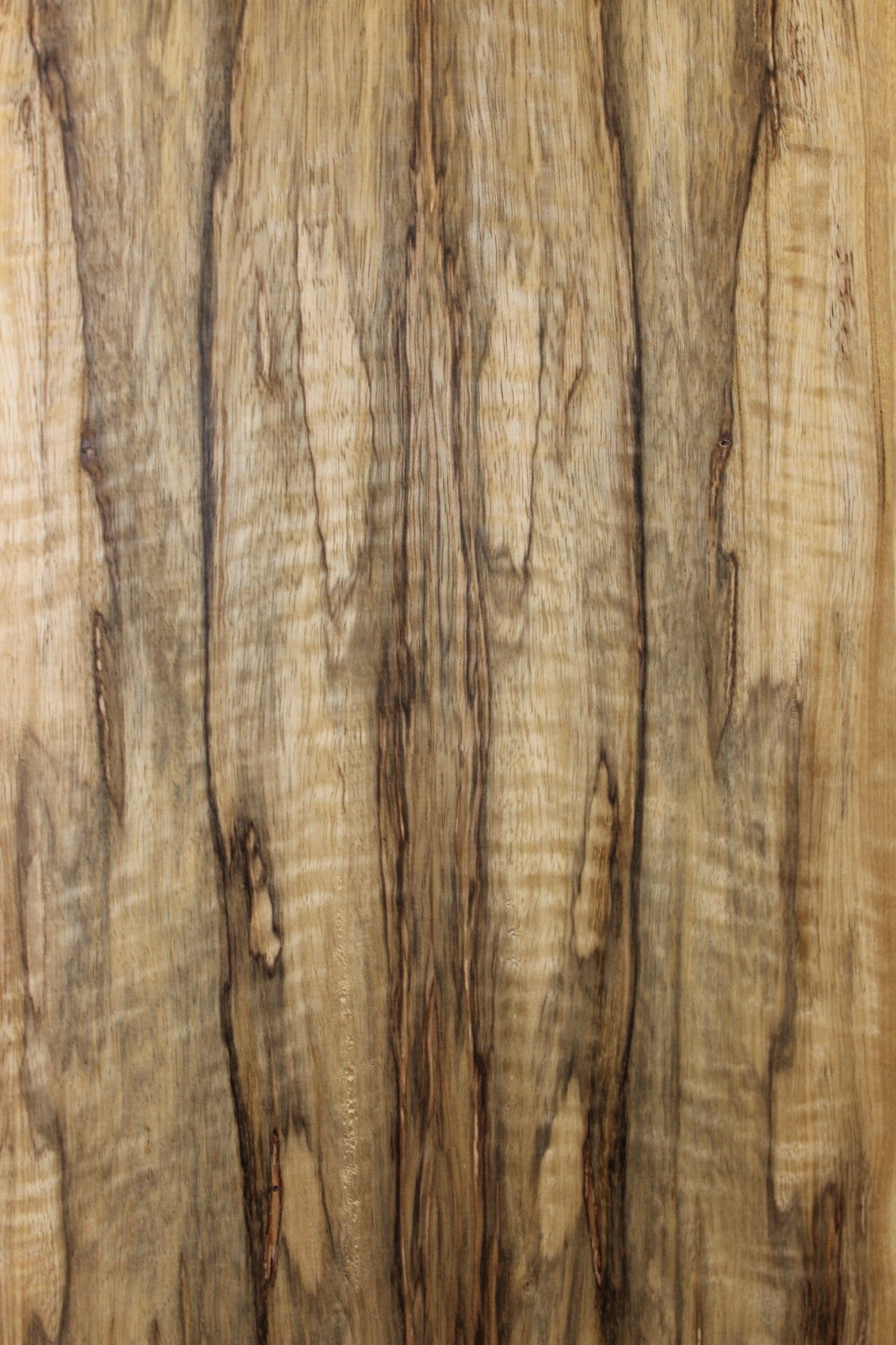 Curly black limba / korina figured book matched guitar top.