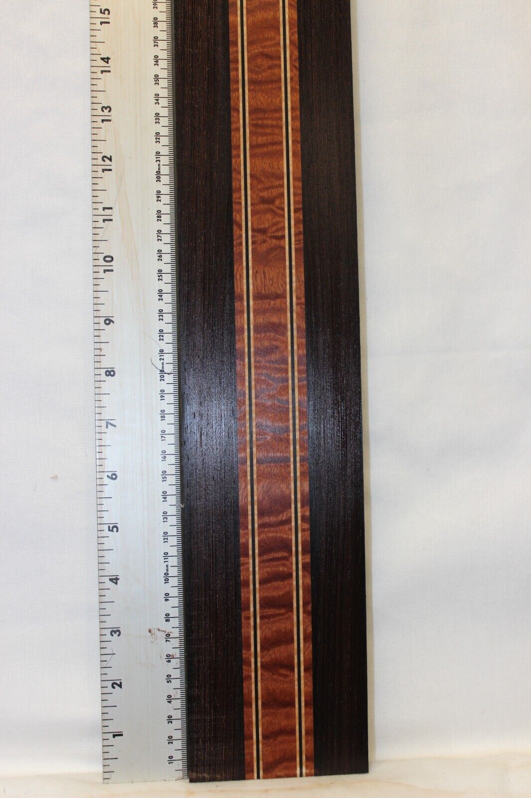 Quilted sapele, wenge and flame maple laminated guitar neck blank.
