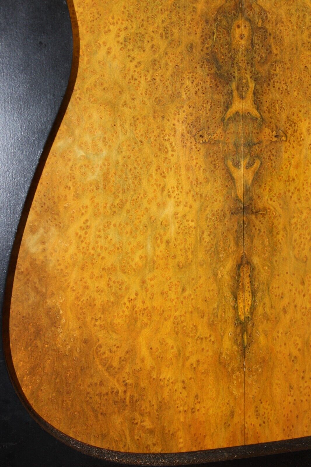 Golden Amboyna burl book matched guitar top.
