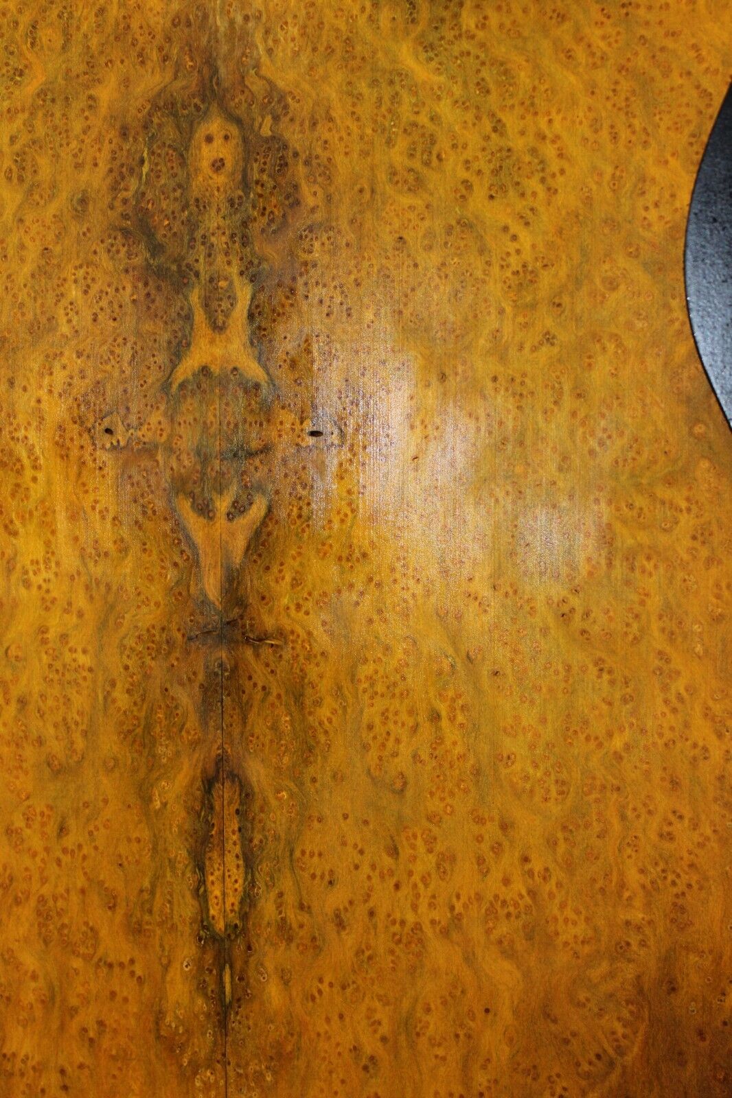 Golden Amboyna burl book matched guitar top.