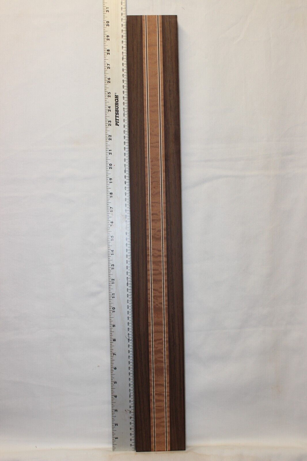 Quilted sapele, wenge and flame maple laminated guitar neck blank.