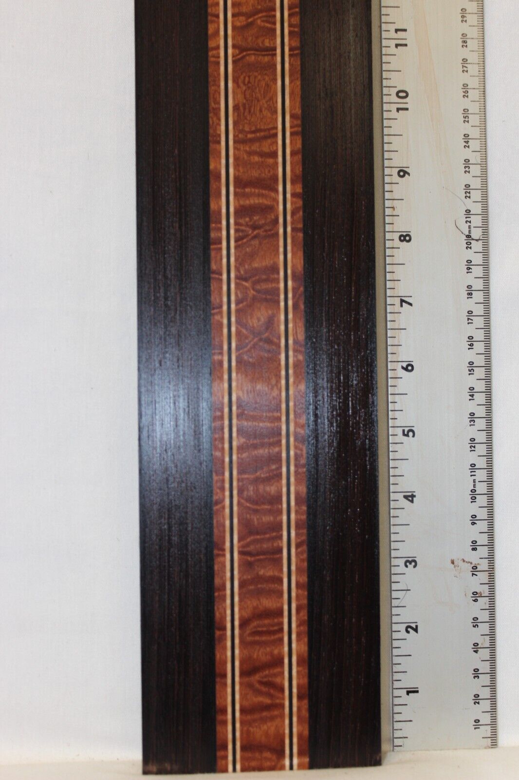 Quilted sapele, wenge and flame maple laminated guitar neck blank.