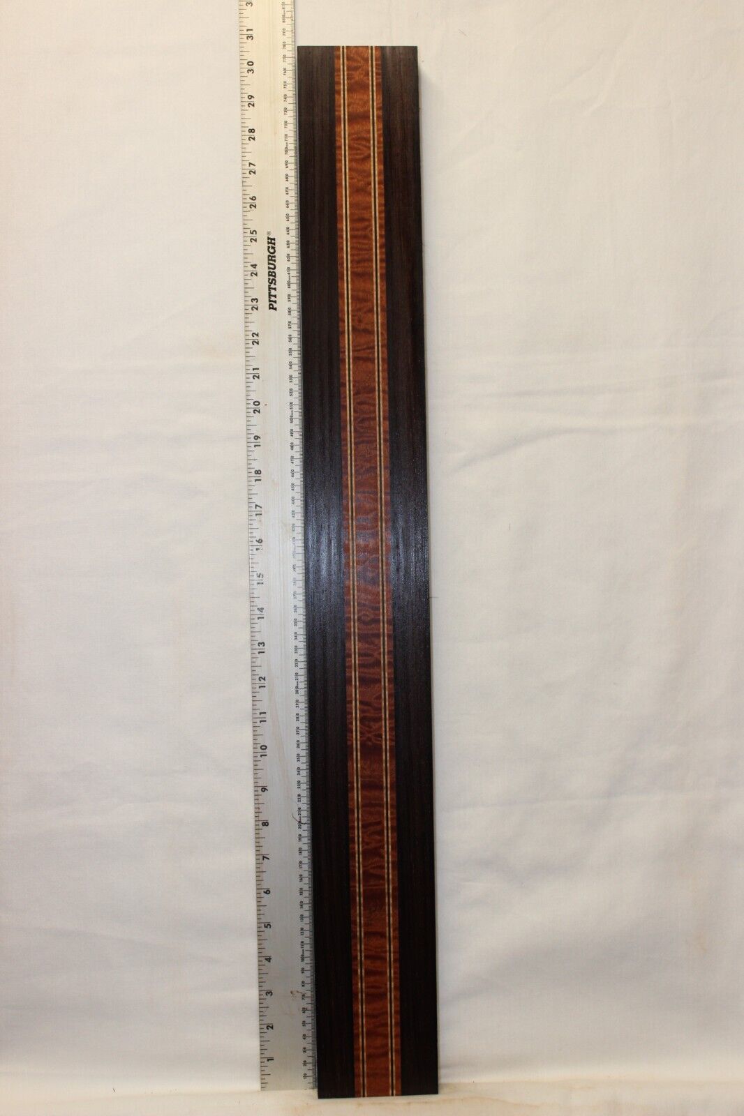 Quilted sapele, wenge and flame maple laminated guitar neck blank.