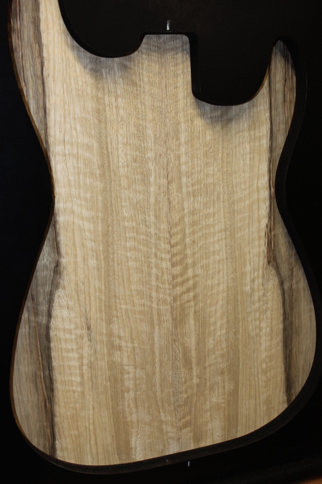 Curly black limba / korina figured book matched guitar top.