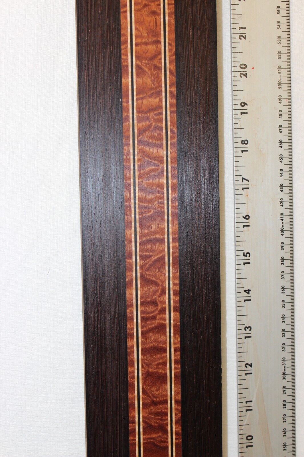 Quilted sapele, wenge and flame maple laminated guitar neck blank.