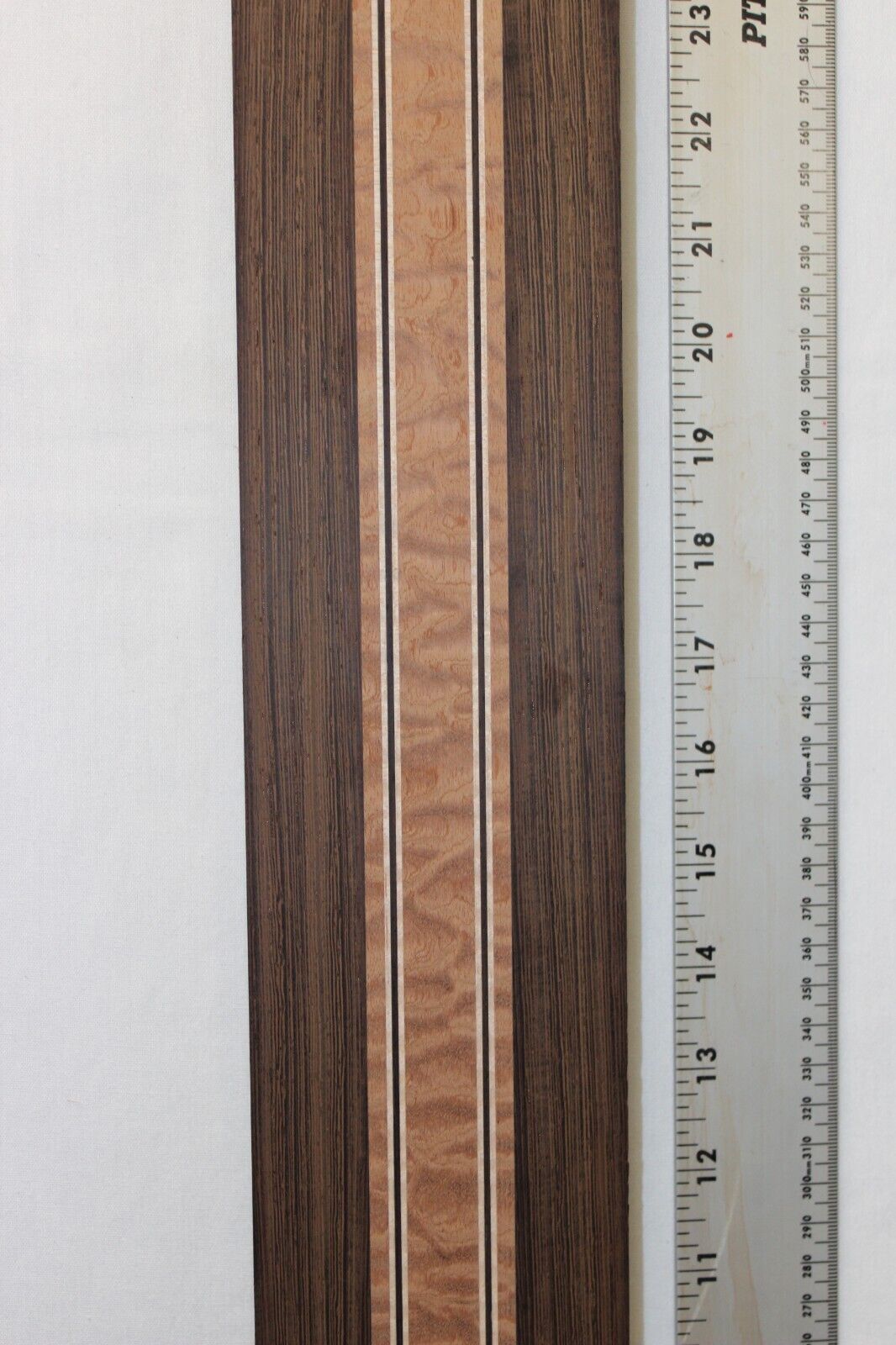Quilted sapele, wenge and flame maple laminated guitar neck blank.