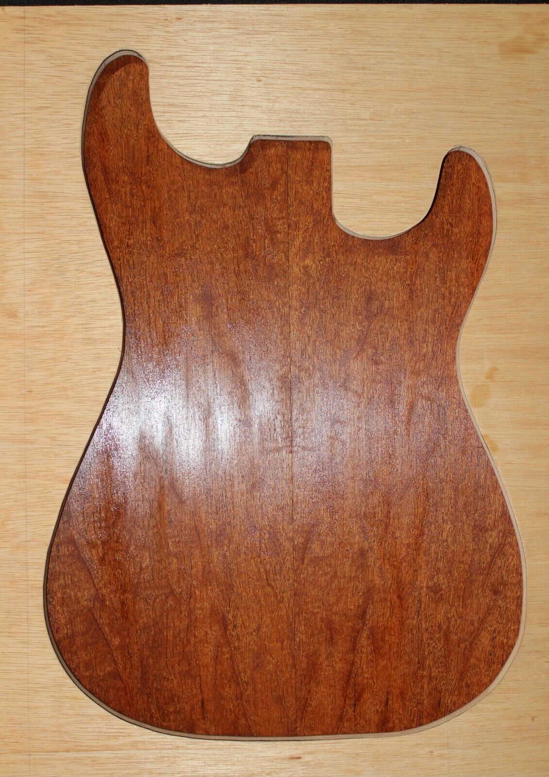 Figured genuine mahogany bookmatched electric guitar drop top.