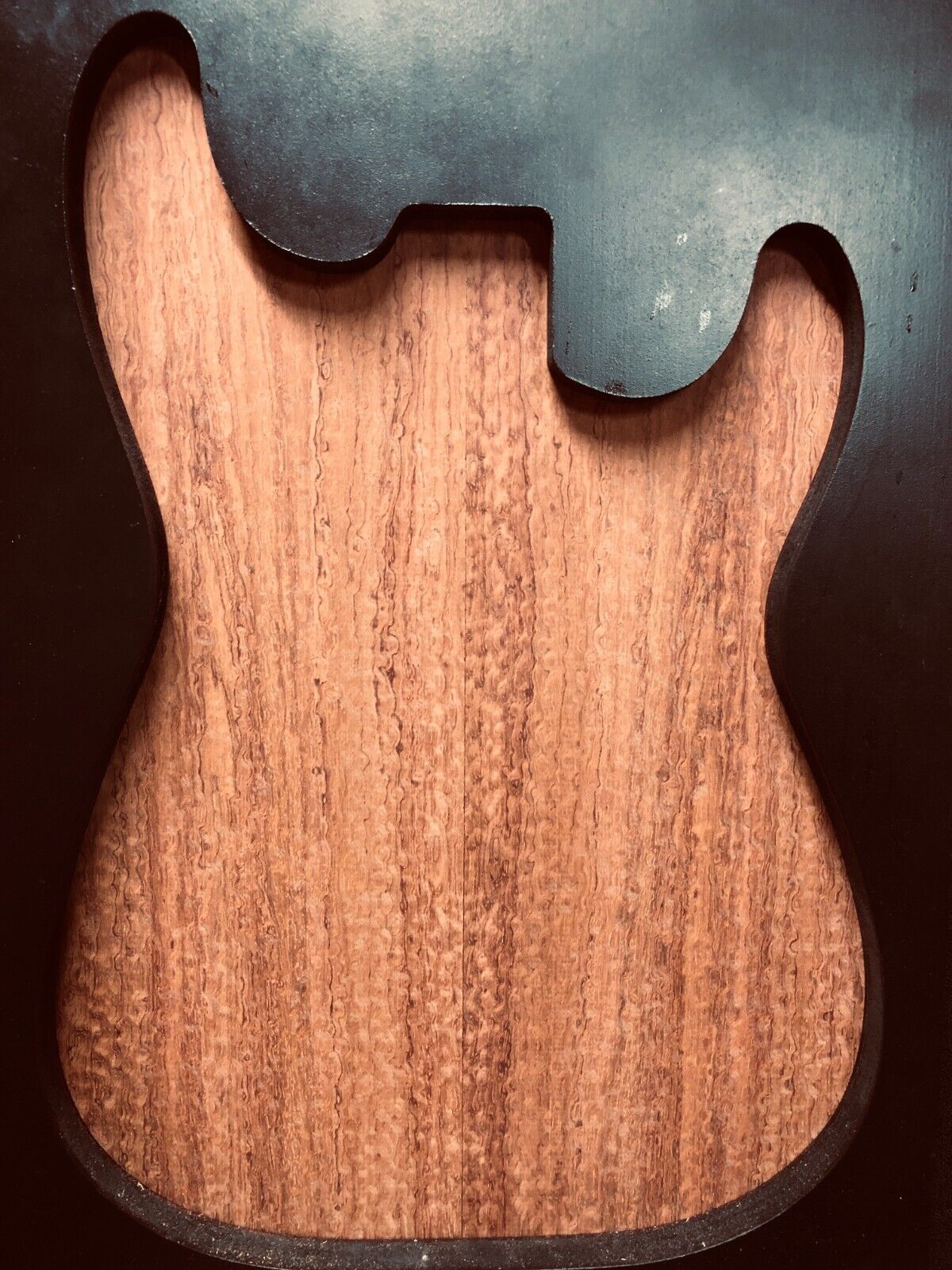 Pomelle figured bubinga electric guitar drop top.
