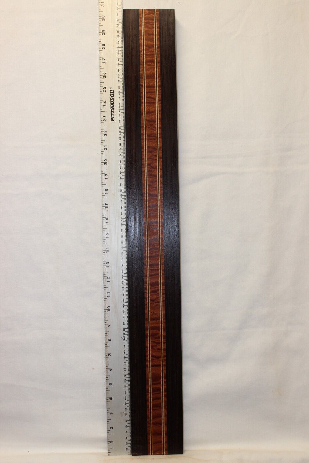 Quilted sapele, wenge and flame maple laminated guitar neck blank.