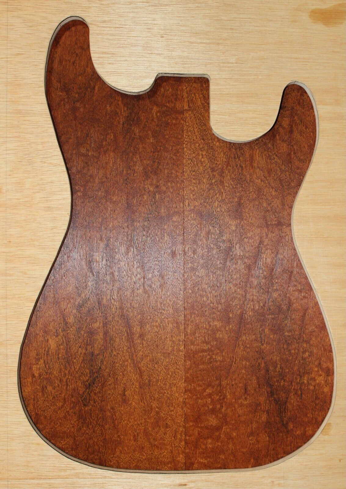 Figured genuine mahogany bookmatched electric guitar drop top.