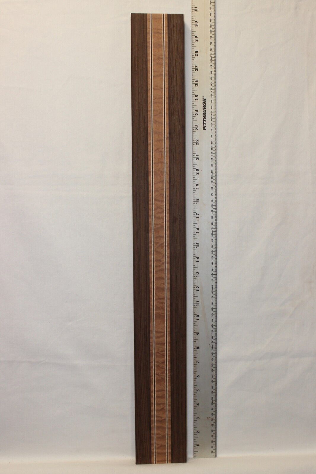 Quilted sapele, wenge and flame maple laminated guitar neck blank.
