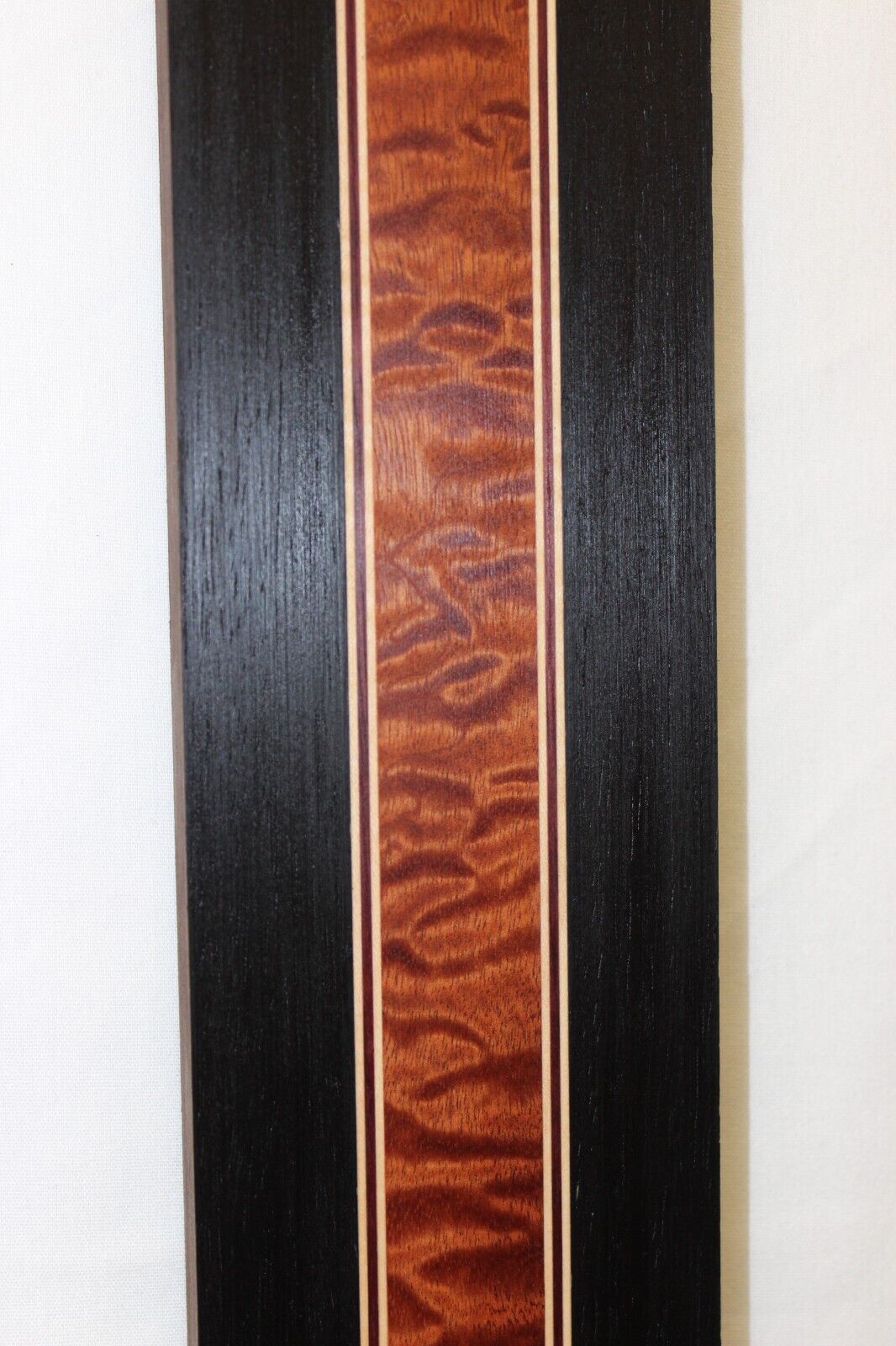 Quilted sapele, wenge, hard maple and purple-heart laminated guitar neck blank.