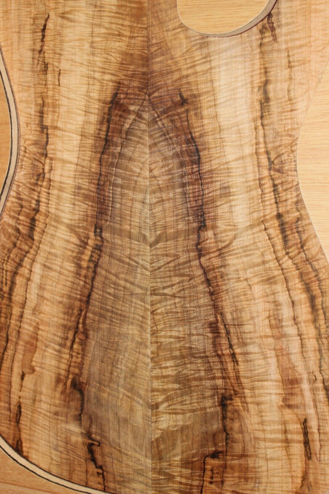 Figured ambrosia maple book matched guitar top, insane figure and color.