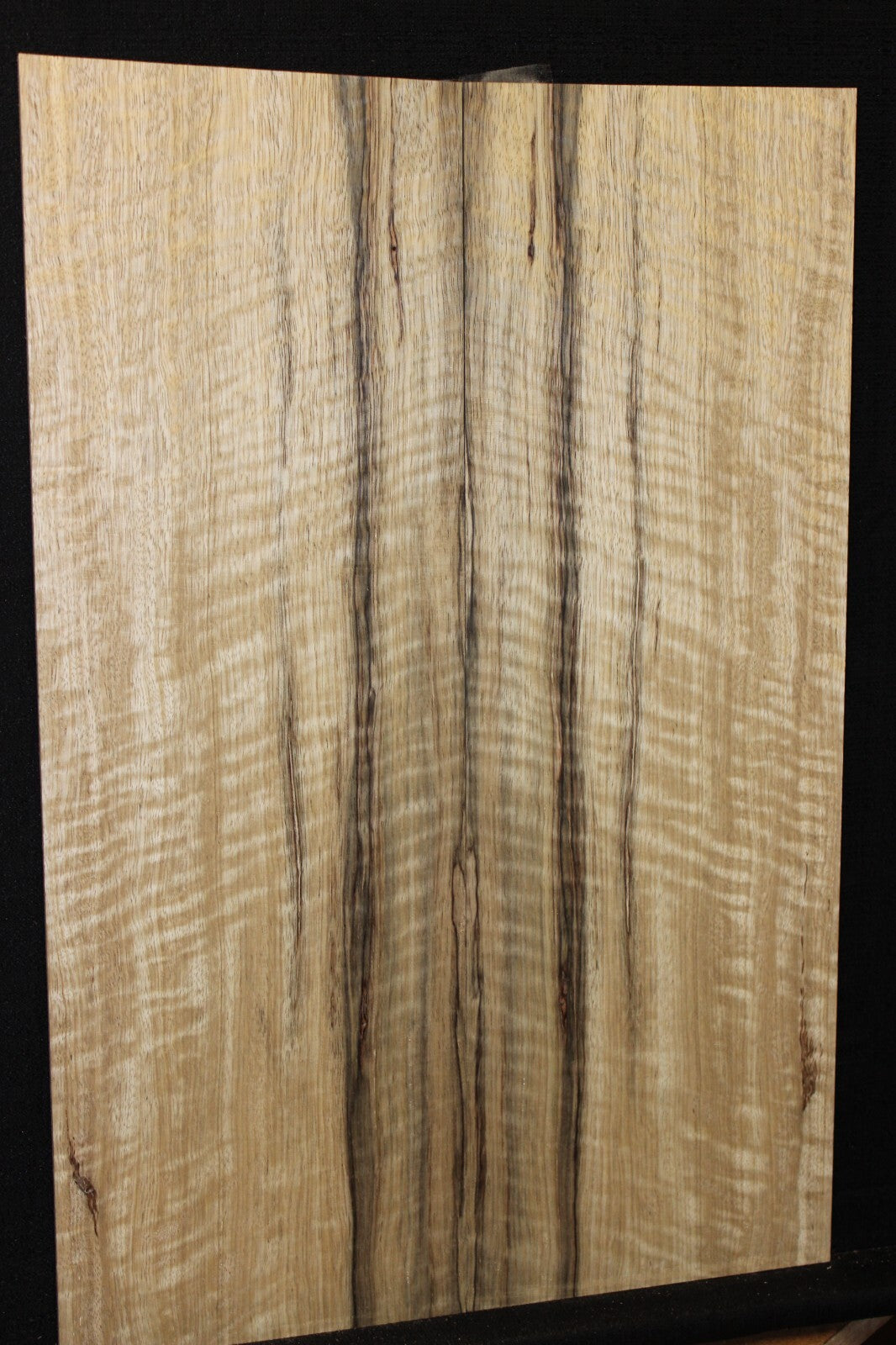 Curly black limba / korina figured book matched guitar top.