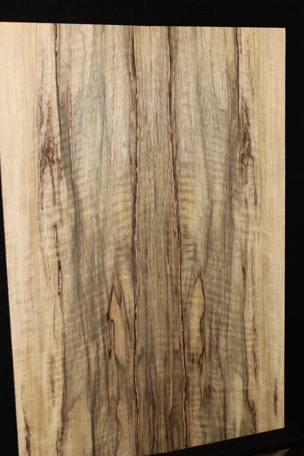 Curly black limba / korina figured book matched guitar top.