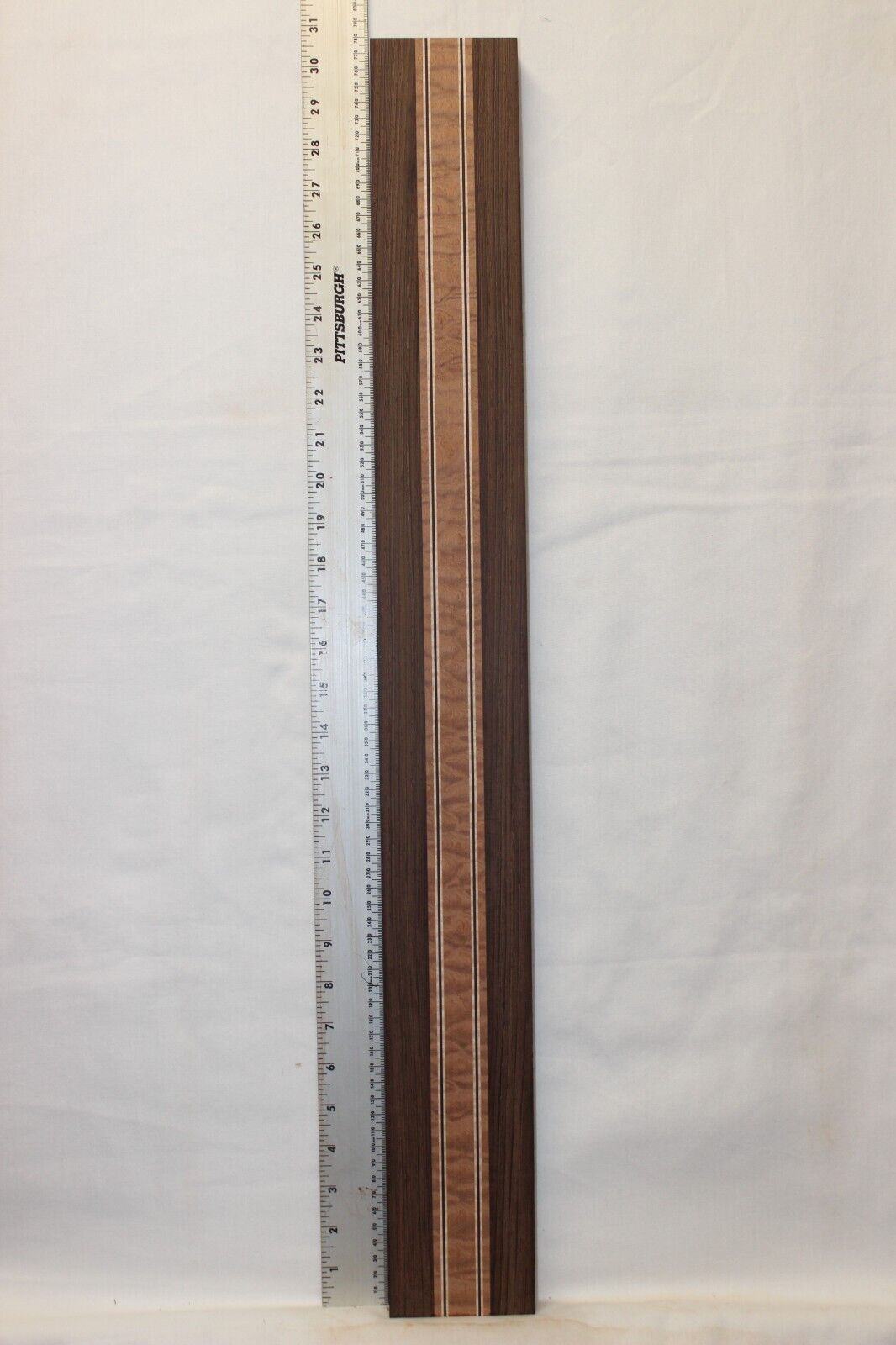 Quilted sapele, wenge and flame maple laminated guitar neck blank.