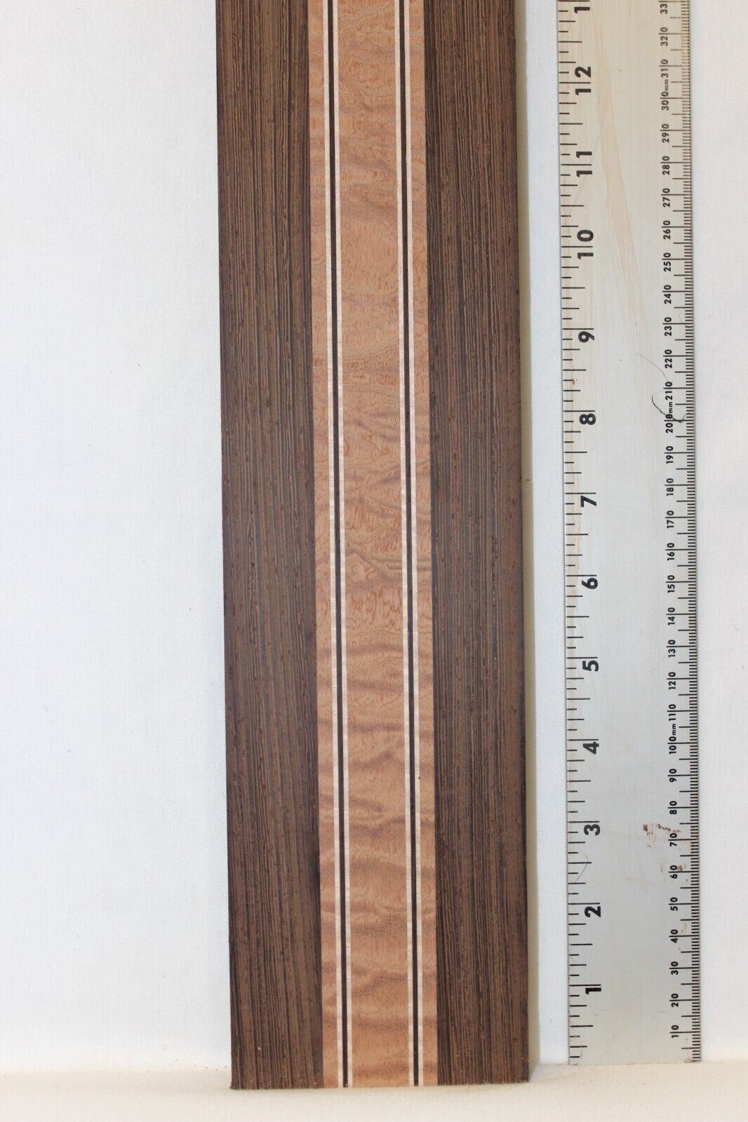 Quilted sapele, wenge and flame maple laminated guitar neck blank.