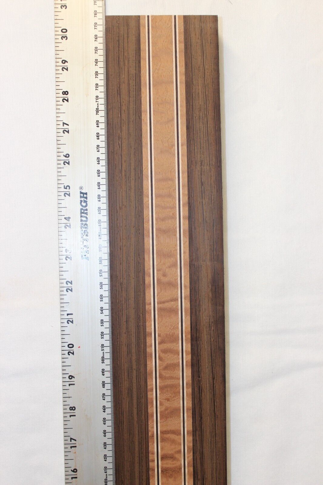 Quilted sapele, wenge and flame maple laminated guitar neck blank.