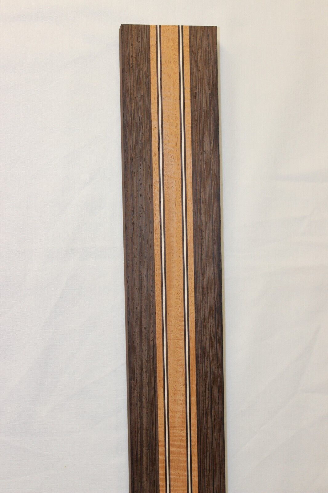 Figured mahogany, wenge and hard maple laminated guitar neck blank.