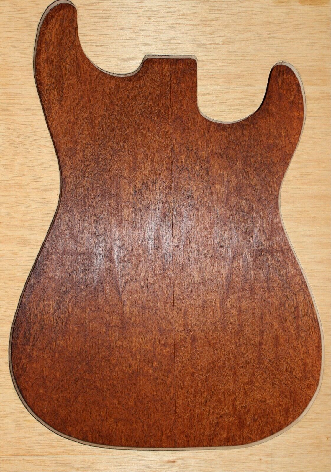 Figured genuine mahogany bookmatched electric guitar drop top.