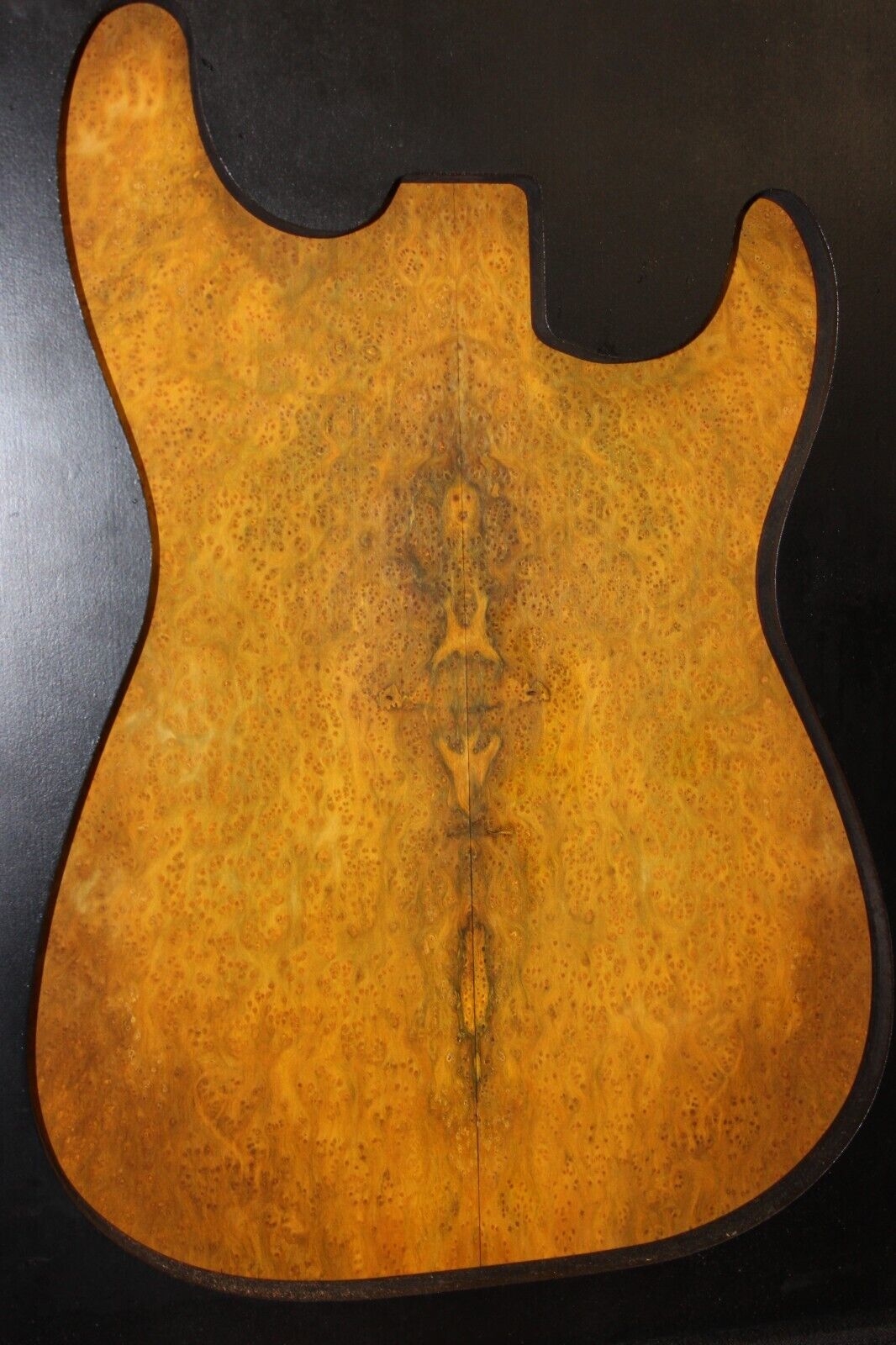 Golden Amboyna burl book matched guitar top.