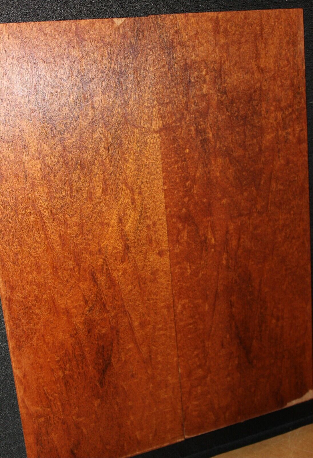 Figured genuine mahogany bookmatched electric guitar drop top.