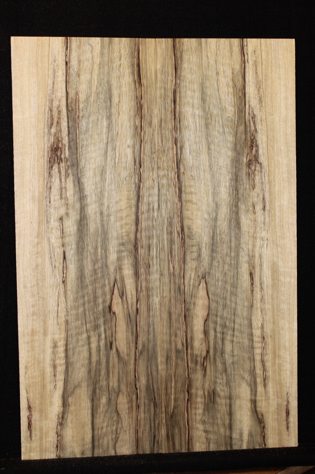 Curly black limba / korina figured book matched guitar top.
