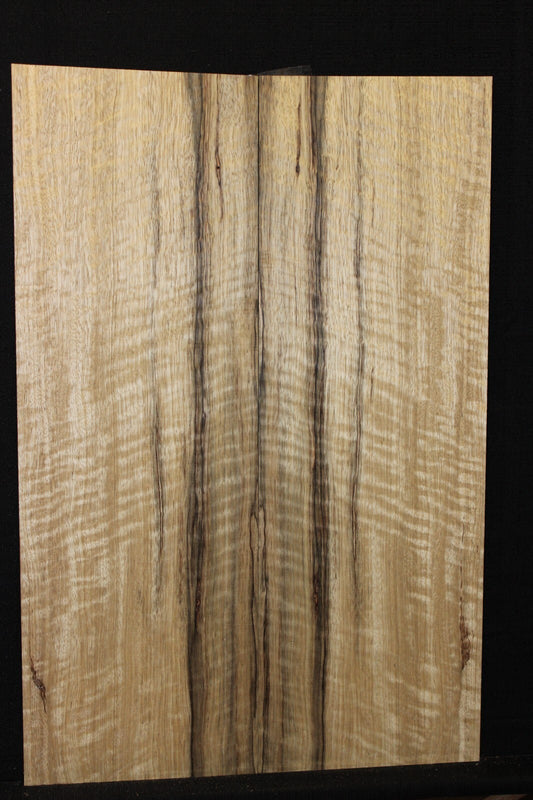 Curly black limba / korina figured book matched guitar top.