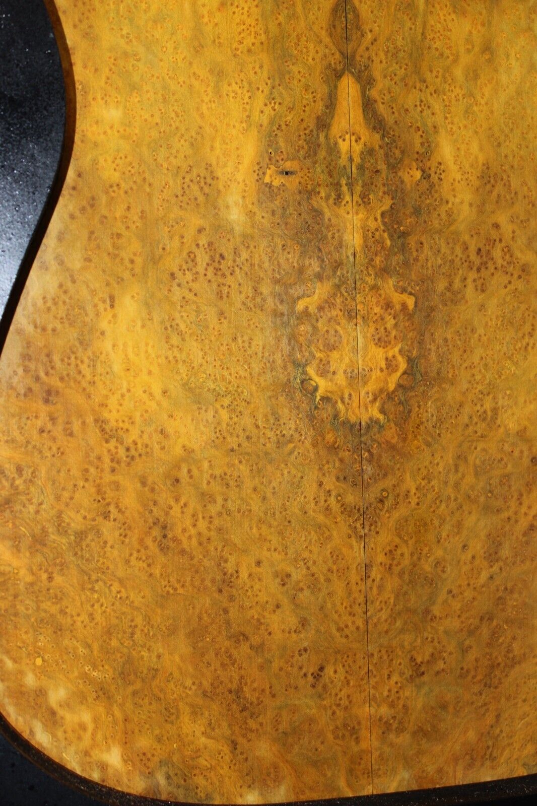 Golden Amboyna burl book matched guitar top.