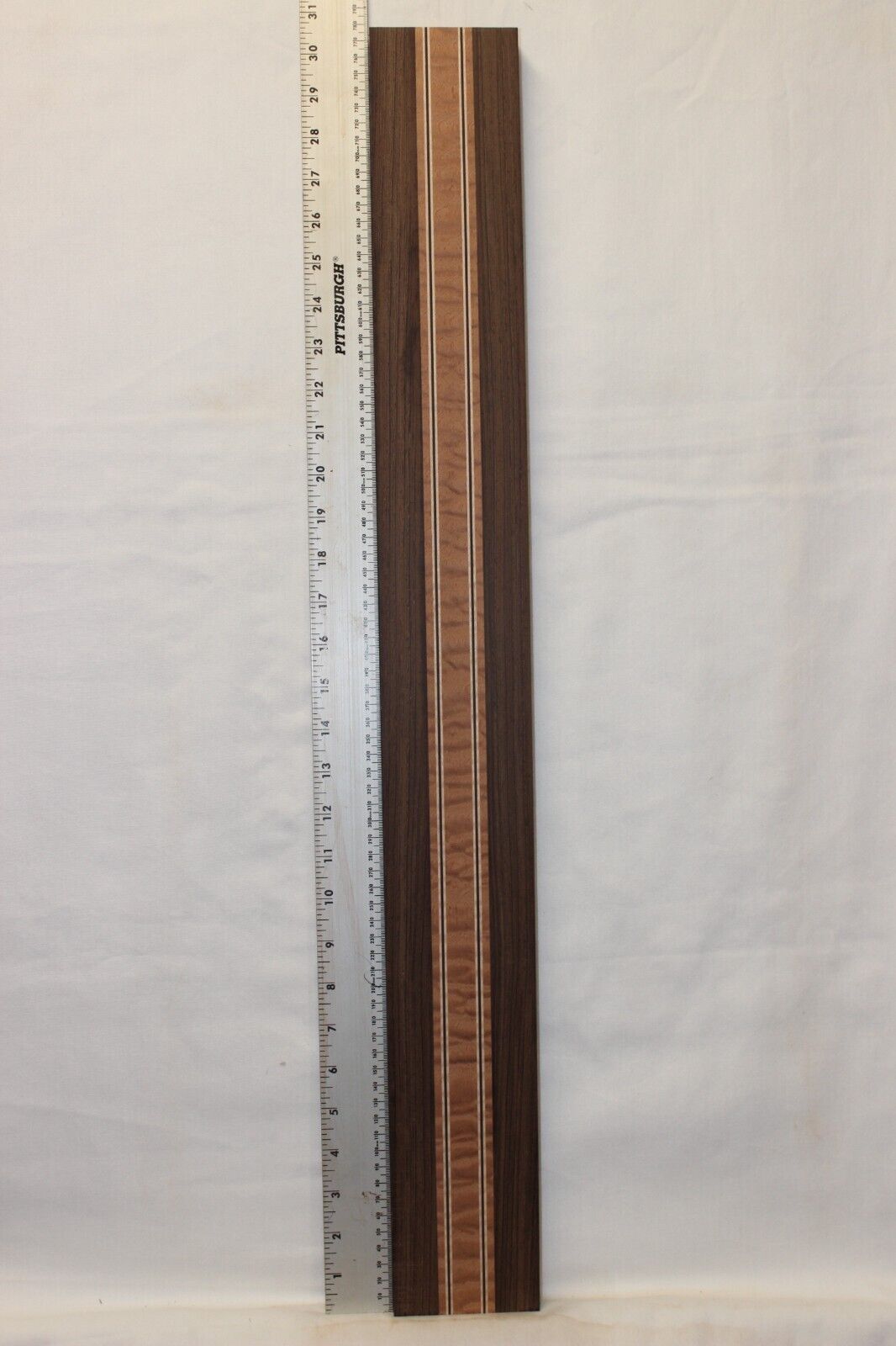 Quilted sapele, wenge and flame maple laminated guitar neck blank.
